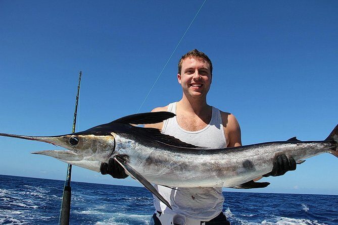 Punta Cana Offshore Deep Sea Fishing Charter - Using the boat’s swim ladder for snorkeling when you want a break